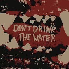 the words don't drink the water are painted on an old red and white background