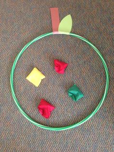 a circle with four pieces of paper on top of it, and one piece of colored paper in the middle