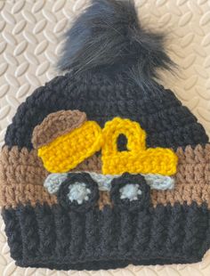 a crocheted hat with a construction truck on it