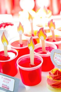 cupcakes with candles in them sitting on a table