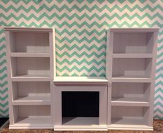 two white bookshelves sitting next to each other in front of a wall with chevron pattern on it