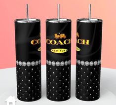 three black and silver canisters with the word coach on them