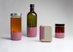 three bottles are shown with one empty bottle and the other half filled with something pink