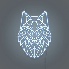 a neon wolf head is shown on a gray background with the light shining through it