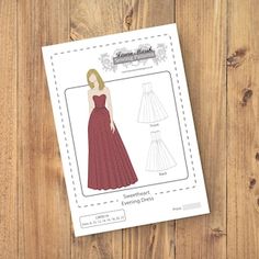 an image of a paper doll on a wooden table with the sewing pattern and instructions to make it