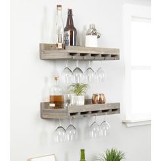 two wooden shelves holding wine glasses and bottles