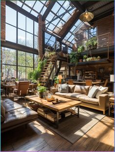 a living room filled with lots of furniture next to tall windows and wooden flooring