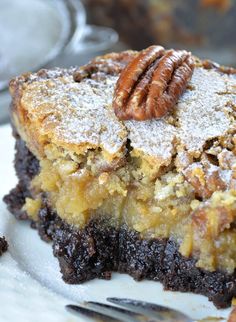 a piece of pecan pie on a plate with a fork