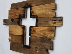 a cross made out of wooden planks on a wall