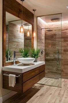 a bathroom with a sink, mirror and shower stall in it's own area