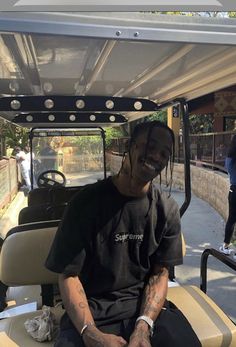 a man sitting in the back of a golf cart