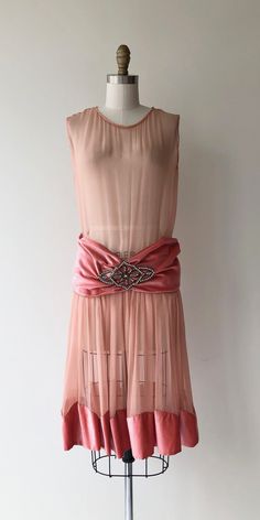 "Antique 1920s pink sheer silk chiffon dress with darker pink silk velvet drop waist and wide pink silk velvet hem, a very large paste stone defines the dress and secures the drop waist velvet. No closures, slips on over the head. [m e a s u r e m e n t s] Fits like: xs/small Bust: 32-34\" Waist: fits 28\" & under Hip: free Length: 41\" [i n f o] Era: n1920s Brand/maker: n/a Fabric content: silk & silk velvet Condition: some very minor underarm discoloration, see close up photo To ensure 1929 Fashion, 20s Flapper Dress, 1920s Clothes, 1920s Day Dress, 1950s Black Dress, 1920 Dress, 20s Dresses, 20s Flapper, 30s Fashion