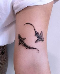 a tattoo on the leg of a woman with an orca whale in it's stomach