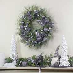 a christmas wreath is hanging on the mantle