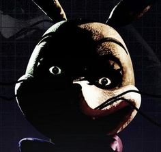 an animated rabbit mask is shown in the dark with its eyes wide open and ears out