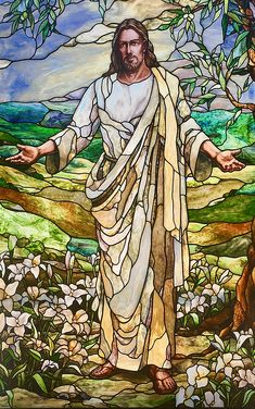 jesus standing in front of a stained glass window with his arms outstretched and hands out