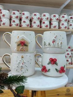 christmas themed coffee mugs on display in a store