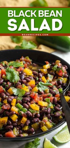 black bean salad in a skillet with limes and cilantro on the side