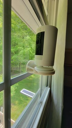 a camera mounted to the side of a window