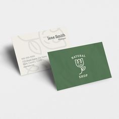 a green and white business card with the name natural shop on it