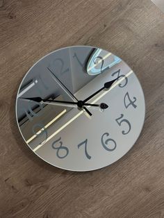 a clock that is sitting on the floor with numbers in it's face and hands