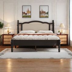 a large bed sitting on top of a hard wood floor next to two paintings above it