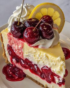 a slice of cheesecake with cherries and whipped cream