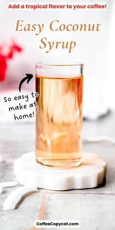 a glass filled with liquid sitting on top of a table