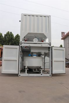 a large white container sitting in the middle of a parking lot