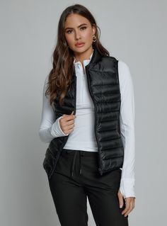 black-1003 Fitted Winter Vest For Outdoor Activities, Fitted Nylon Vest For Cold Weather, Fitted Black Travel Outerwear, Fitted Black Outerwear For Travel, Black Athleisure Outerwear For Hiking, Functional Sleeveless Travel Vest, Black Vest For Hiking In Fall, Black Nylon Vest With Zipper Closure, Athleisure Sleeveless Outdoor Outerwear