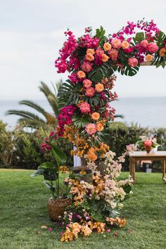 an arch made out of flowers in the grass