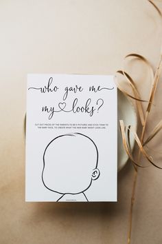 a card with the words who gave me my looks? on it next to a plant