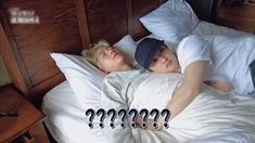 two people laying in bed with question marks on the pillow