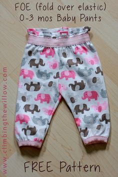 a baby pants with pink elephants on it