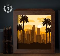 a wooden frame with an image of palm trees in front of a cityscape