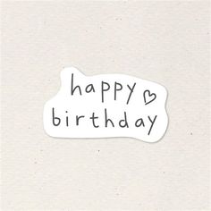 a white sticker with the words happy birthday written in black ink on top of it