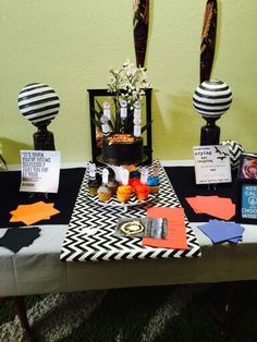 a table topped with lots of decorations and paper cutouts on it's sides