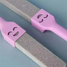 two pieces of pink and grey concrete with holes in them