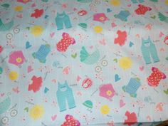 a close up of a colorful fabric with animals and hearts on it's surface