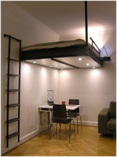 a room with a loft bed next to a couch and table in it, which also has a ladder