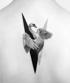 the back of a woman's neck with a swan and triangle tattoo on it