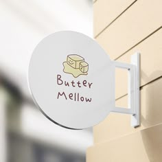 a sign on the side of a building that says butter mellow next to a wall