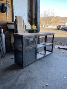 a metal cabinet sitting on top of a cement floor next to a building with lots of windows