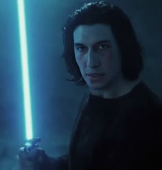 a man holding a light saber in his hand