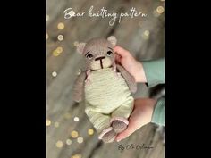 a hand holding a small teddy bear in a knitted outfit with the caption bebe knitting pattern