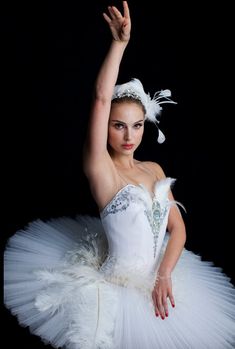 a woman in a white tutu posing for the camera