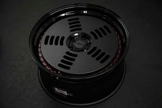 a black wheel with red lights on it