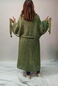 Only ONE COPYUNIQUELY Women handmade knitwear OVERSIZE COATLoose shoulder sleeve overcoat Elegant long cardigan - coat with beltHand knitSoft GREEN YELLOW melange.26% wool, 15% mohair, 40% PA 19% nylonLength 125 cmSleeve + shoulder 74 cmCare recommendationsDry cleaning or hand wash at temperatures up to 30 ° C.We do not recommend using car drying.To dry the cardigan, please lay it out on a flat surface.Coat is ready for shipmentFree shippingYou can read in the shop policy about the delivery time Green Oversized Long Outerwear, One Size Long Knitted Sweater Coat, Long Green Winter Sweater, Long Green Sweater Coat For Fall, Spring Long Chunky Knit Sweater Coat, Long Green Sweater For Fall, Long Green Fall Sweater, Hand Knitted Long Outerwear For Fall, Casual Long Hand Knitted Sweater Coat