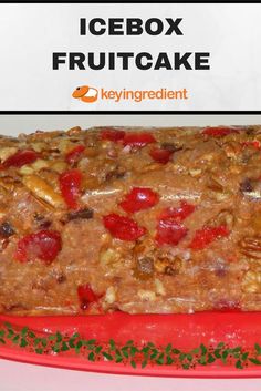 a red plate topped with fruit cake next to a sign that says icebox fruitcake