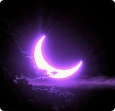 the moon is in the dark sky with clouds around it and purple light coming from behind